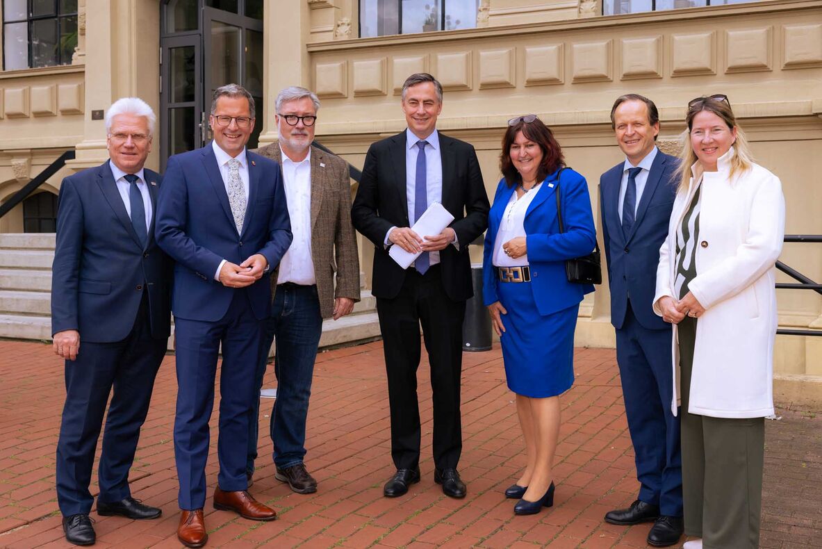 Gruppenfoto mit der Hochschulleitung, Stades Landrat Kai Seefried, der CDU-Landtagsabgeordnete Birgit Butter und David McAllister, Mitglied des Europäischen Parlaments vor dem Hochschulgebäude.